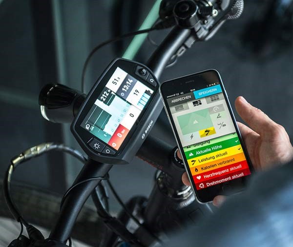 a eBike rider checking out his stats of his ride on his smartphone
